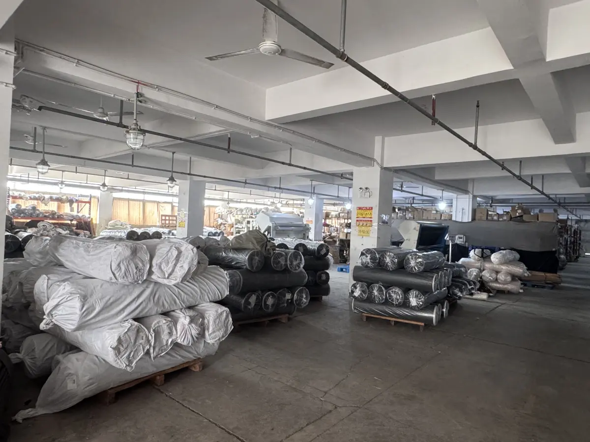 Denim fabric rolls stacked on pallets in the warehouse