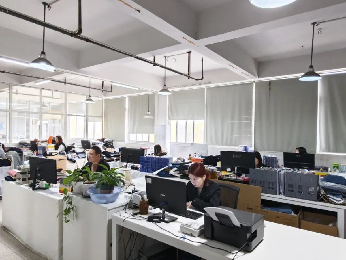 Product development team working at computers in the factory office
